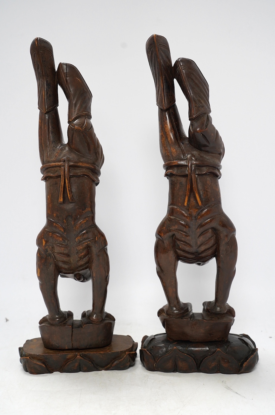 Two Chinese carved rosewood figures of acrobats, 42cm high. Condition - fair to good, polish worn in places